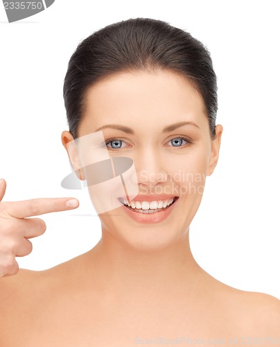 Image of beautiful woman pointing to teeth