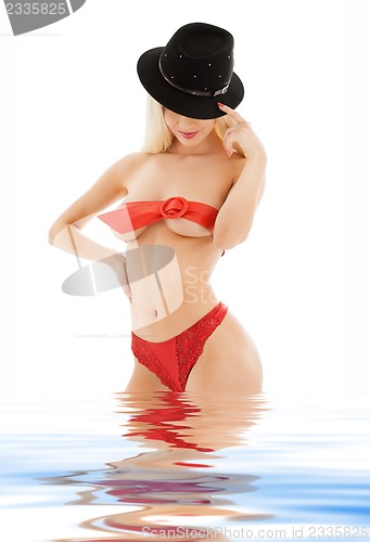 Image of playful girl in red belt and black hat