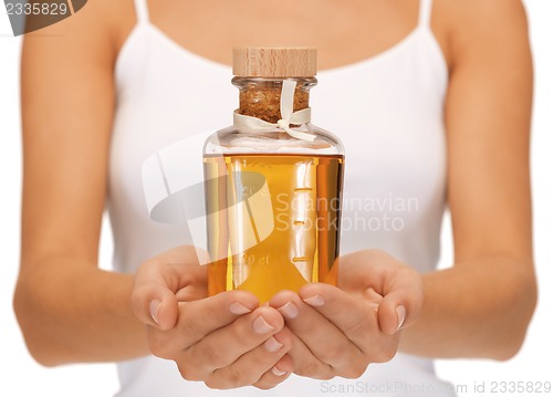 Image of female hands with oil bottle
