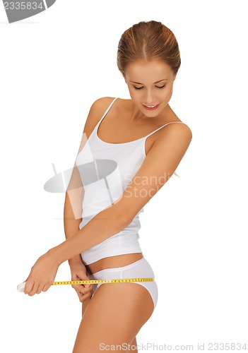 Image of woman measuring her hips