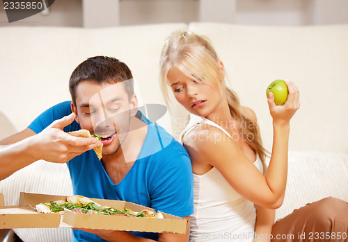 Image of couple eating different food