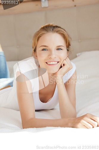 Image of smiling teenage girl on a bed