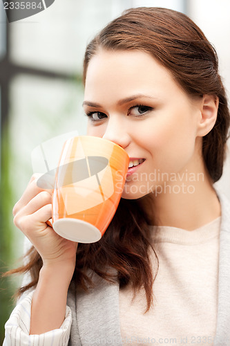 Image of lovely businesswoman with mug