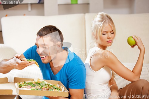 Image of couple eating different food