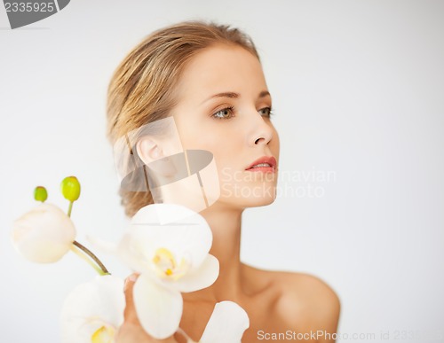 Image of lovely woman with orchid flower