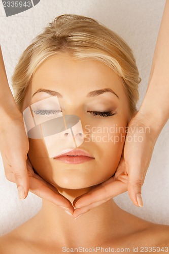 Image of beautiful woman in massage salon