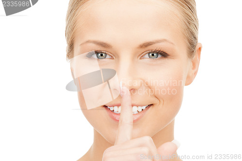 Image of happy woman with finger on lips