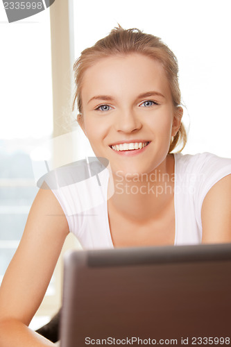 Image of happy teenage girl with laptop computer