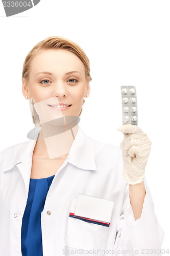 Image of attractive female doctor with pills