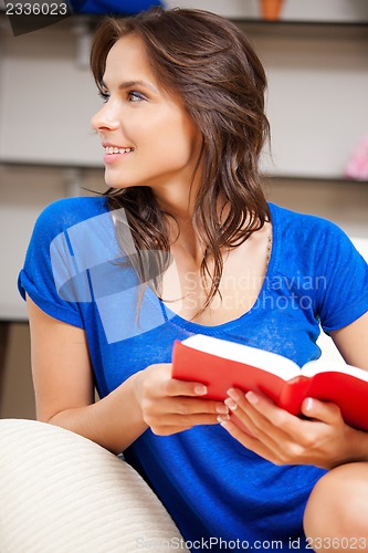 Image of happy and smiling woman with book