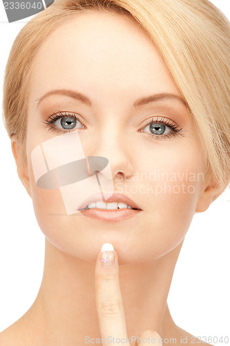Image of beautiful woman pointing to chin