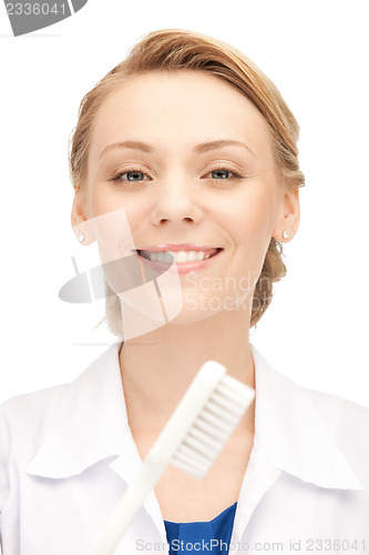 Image of attractive female doctor with toothbrush