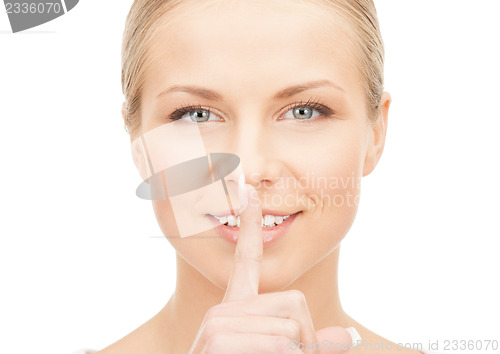 Image of happy woman with finger on lips