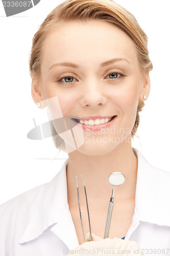 Image of attractive female dentist with tools