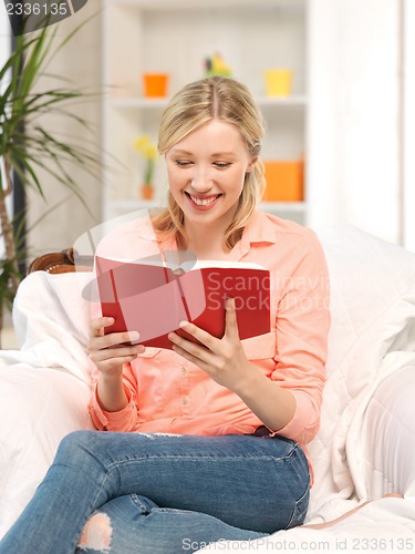 Image of happy and smiling woman with book