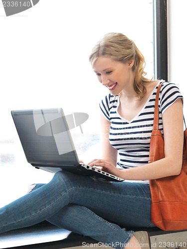 Image of happy teenage girl with laptop computer