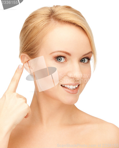 Image of beautiful woman pointing to ear