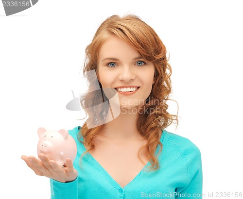 Image of teenage girl with piggy bank