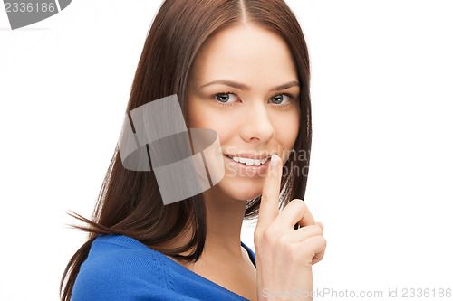 Image of happy woman with finger on lips
