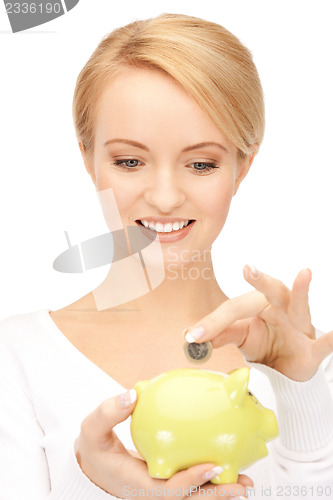 Image of lovely woman with piggy bank and money