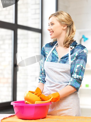 Image of housewife washing dish at the kitchen