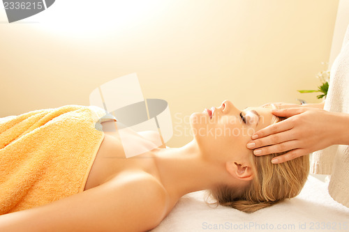 Image of beautiful woman in massage salon