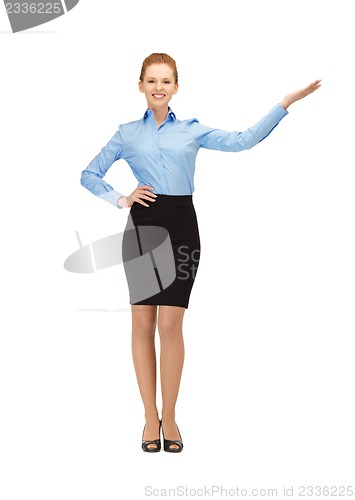 Image of smiling stewardess showing direction