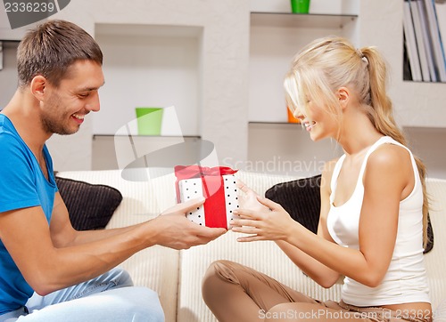 Image of happy romantic couple with gift