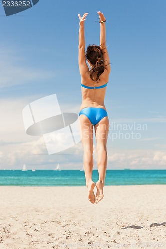 Image of jumping woman on the beach