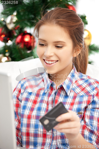 Image of woman with laptop computer and credit card