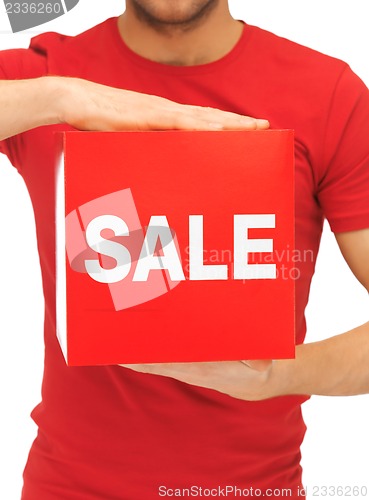 Image of man holding sale sign