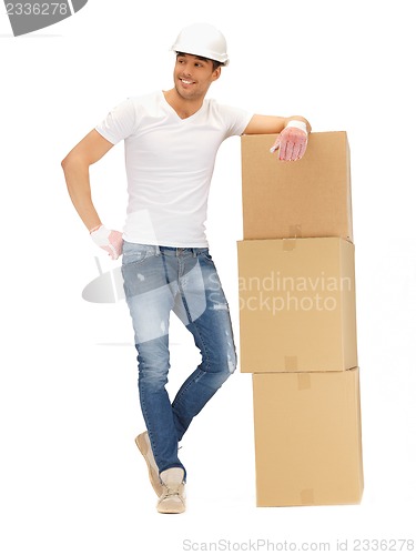 Image of handsome builder with big boxes