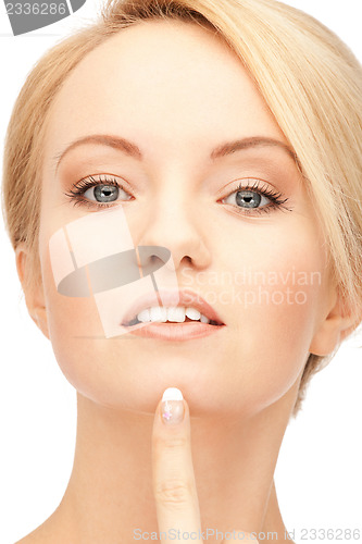 Image of beautiful woman pointing to chin