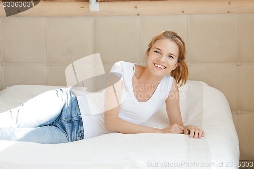 Image of smiling teenage girl on a bed