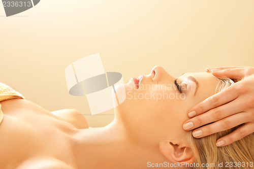 Image of beautiful woman in massage salon