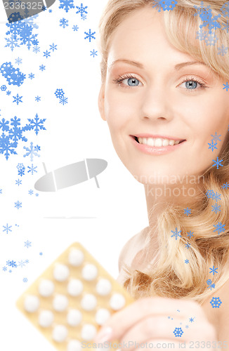 Image of young woman with pills