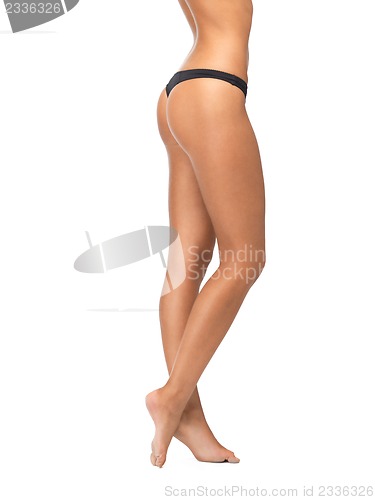 Image of female legs in black bikini panties