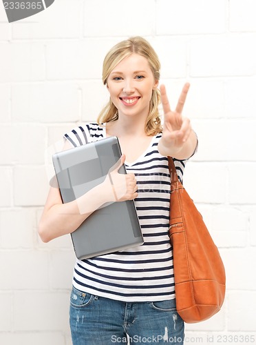 Image of smiling teenage girl with laptop