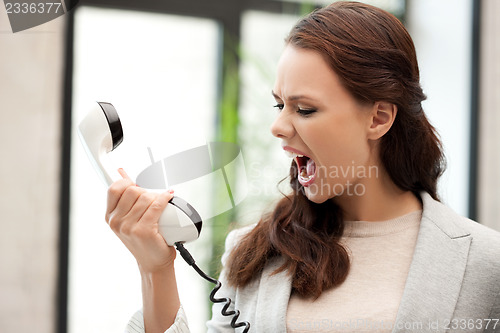 Image of angry businesswoman with phone