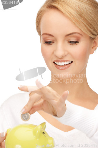 Image of lovely woman with piggy bank and money