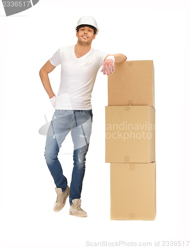 Image of handsome builder with big boxes