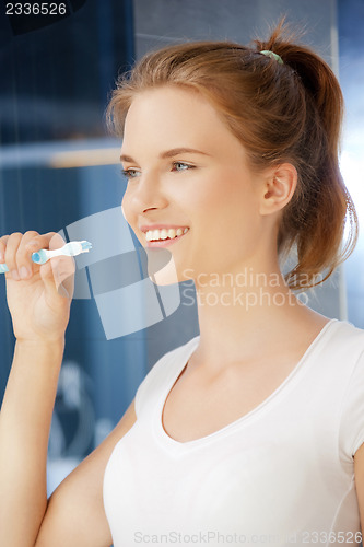 Image of smiling teenage girl with toothbrush