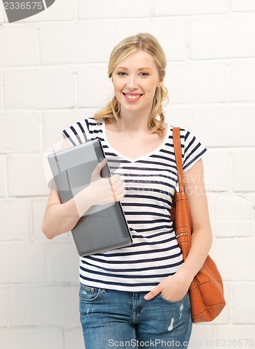 Image of happy and smiling teenage girl with laptop
