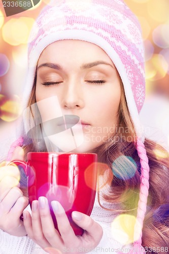 Image of beautiful woman with red mug