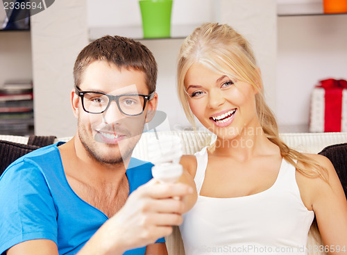 Image of couple holding energy saving bulb