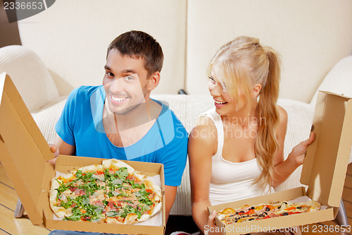 Image of romantic couple eating pizza at home
