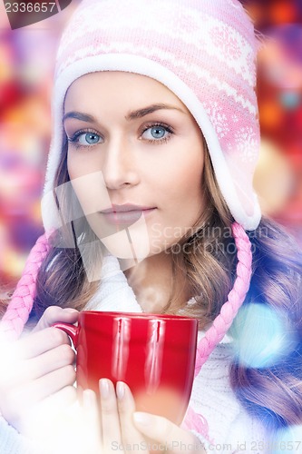Image of beautiful woman with red mug