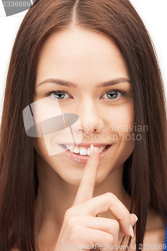 Image of happy woman with finger on lips