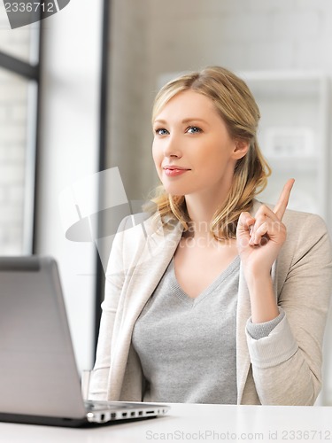 Image of woman with laptop and finger up