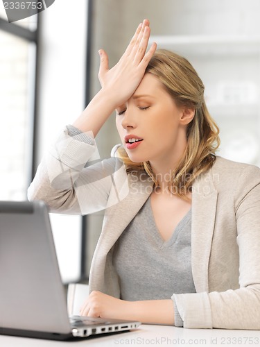 Image of stressed woman with laptop computer